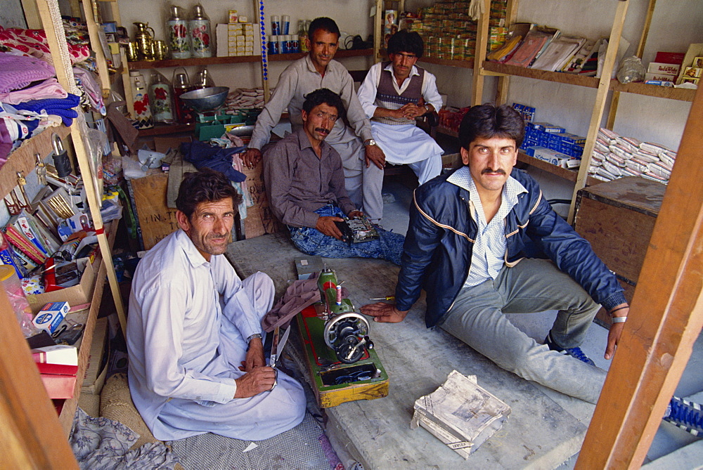 A group of men in a combined shop and workshop in Upper Hunza in the Hunza Valley, Pakistan, Asia