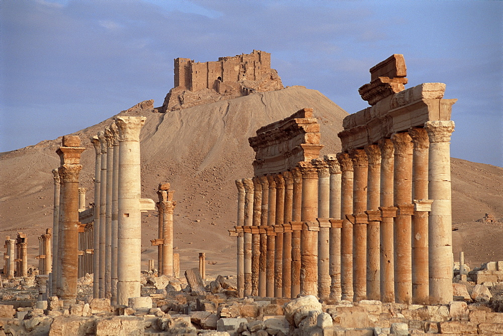 The Great Colonnade, with Arab castle on hill in background, Palmyra, UNESCO World Heritage Site, Syria, Middle East