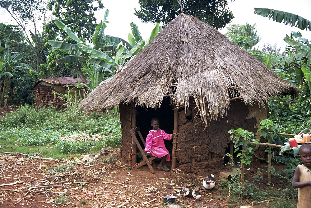 Little girl dressed for church, in front of hut, Uganda, East Africa, Africa