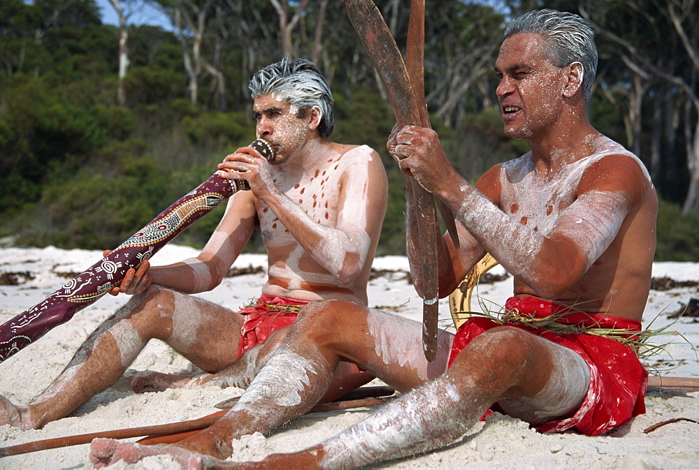 Two men with Aboriginal digeridoo and boomerang at Jervis Bay, Australia, Pacific