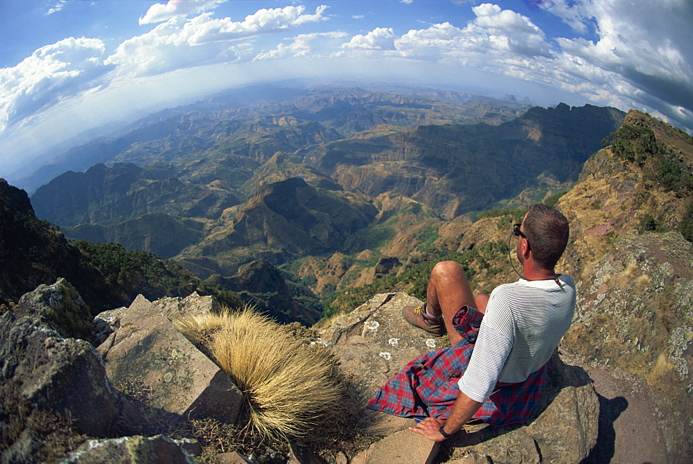 Tourist viewing breathtaking views at 14000 ft, Simien Mountains, Ethiopia, Africa