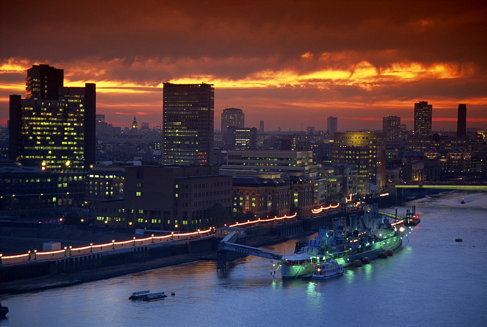 HMS Belfast moored on the Thames, illuminated at dusk, London, England, United Kingdom, Europe