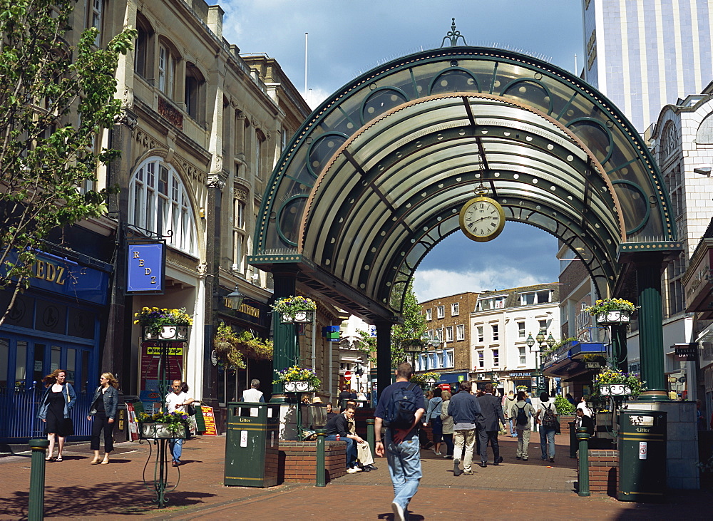 Entrance to shopping arcade with clock on a pedestrianised street off The Square, Bournemouth, Dorset, England, United Kingdom, Europe