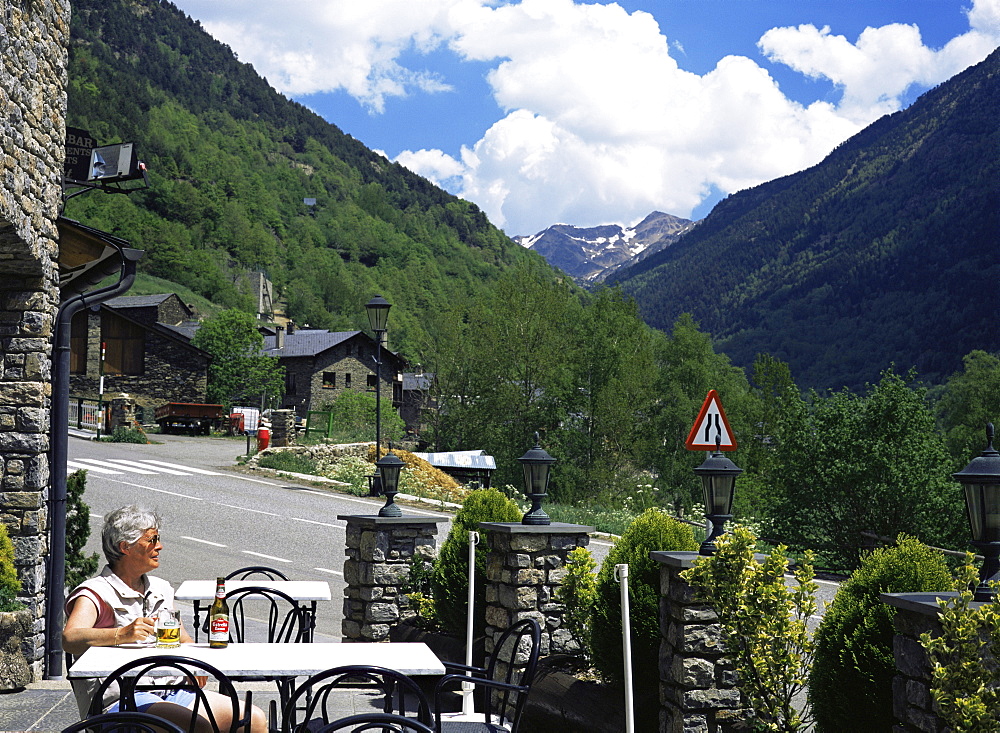 Tourist drinking beer in roadside bar, Llorts, Parish of Ordino, Ordino Valley, Andorra, Europe