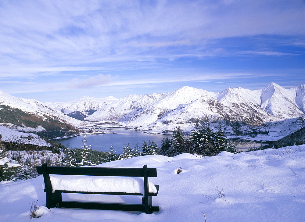 Bench at Bealach Ratagain viewpoint looking towrds the head of Loch Duich in Glen Sheil after a heavy snow fall, Ratagain Pass, Highland region, Scotland, United Kingdom, Europe