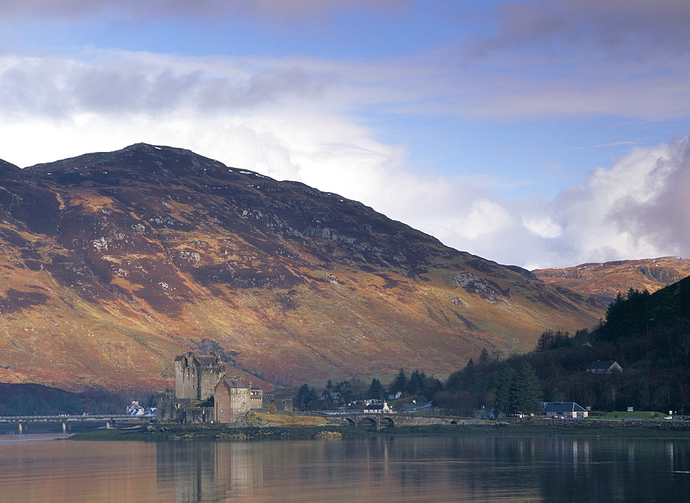 Eilean Donan castle reflected in the calm water of Loch Duich from Totaig, Dornie, Highland region, Scotland, United Kingdom, Europe