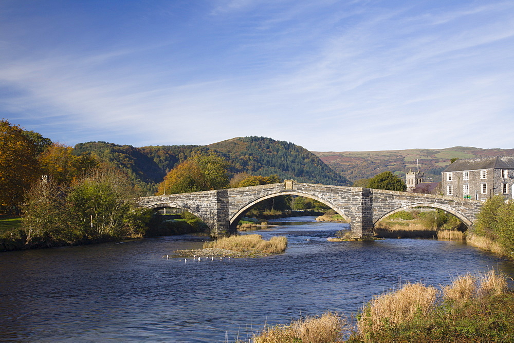 Pont Fawr Bridge, arched stone bridge built by Inigo Jones in 1636, Conwy River, and in autumn with mountains in Snowdonia National Park beyond, Llanrwst, Conwy, Wales, United Kingdom, Europe