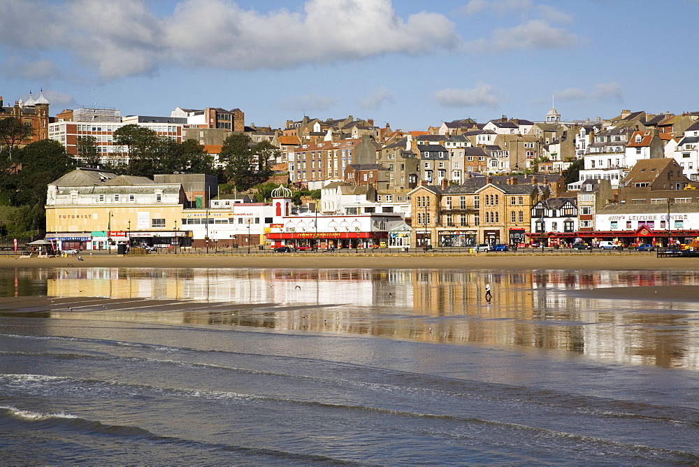 South Sands in South Bay at low tide with seafront buildings reflected in wet sand on beach, Scarborough, North Yorkshire, England, United Kingdom, Europe