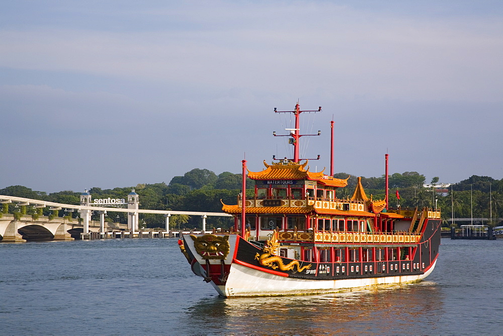 Old Chinese junk used as tour boat for tourist harbour cruise, with road bridge and new monorail to Sentosa Island beyond, Keppel Channel, Singapore, Southeast Asia, Asia