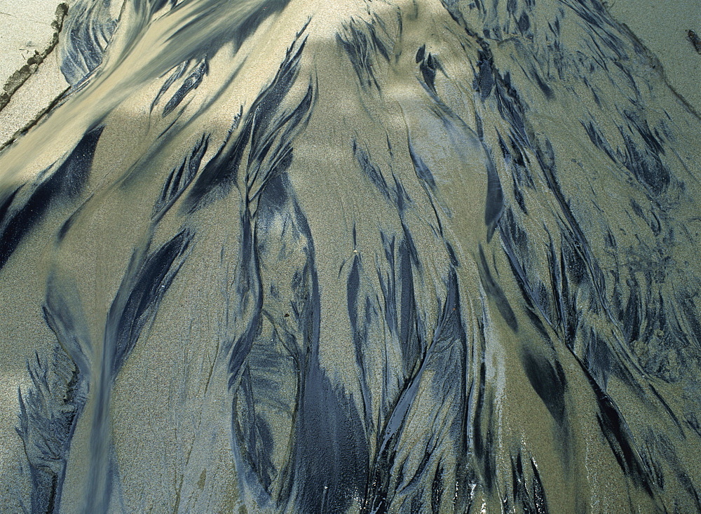 Sand patterns in water, dark volcanic sand lying just below white sand, Manuel Antonio National Park, Quepos, Costa Rica, Central America