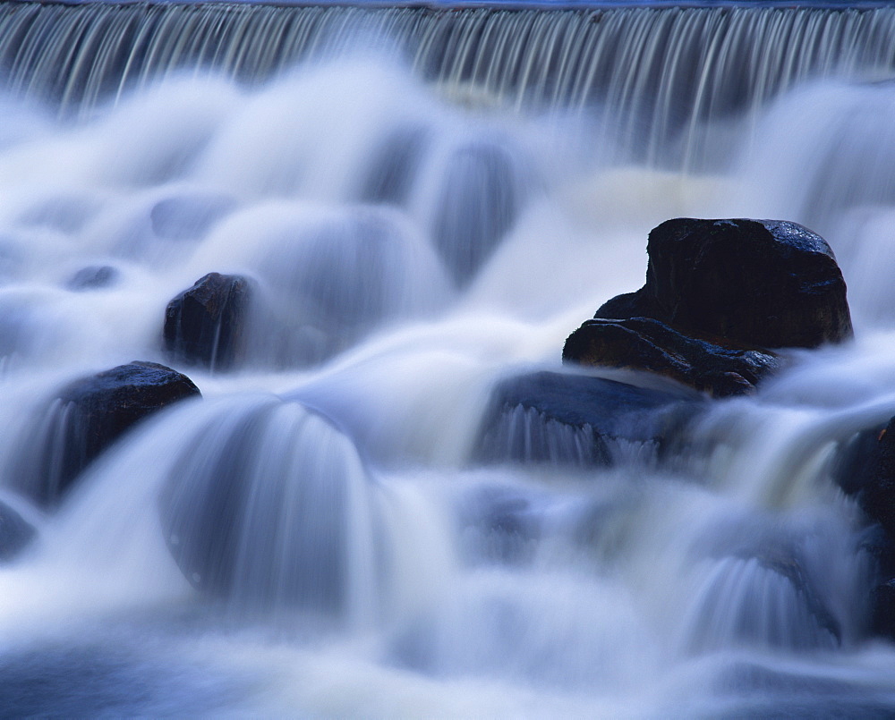 Close-up of waterfall, water cascading over rocks in the Highlands of Scotland, United Kingdom, Europe