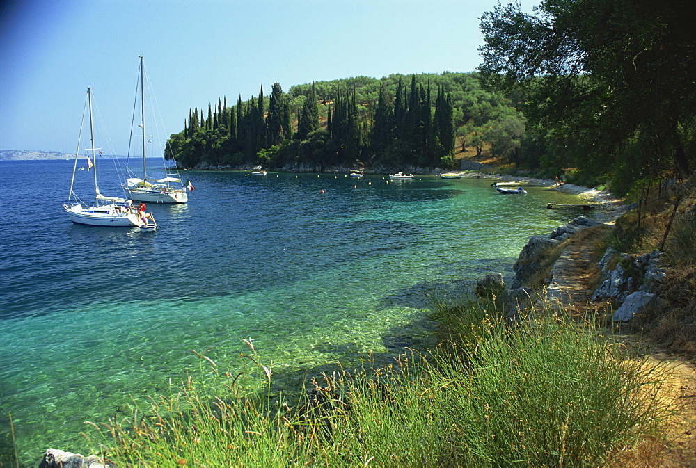 Yachts moored offshore in Kalami Bay on the coast, Corfu, Ionian Islands, Greek Islands, Greece, Europe