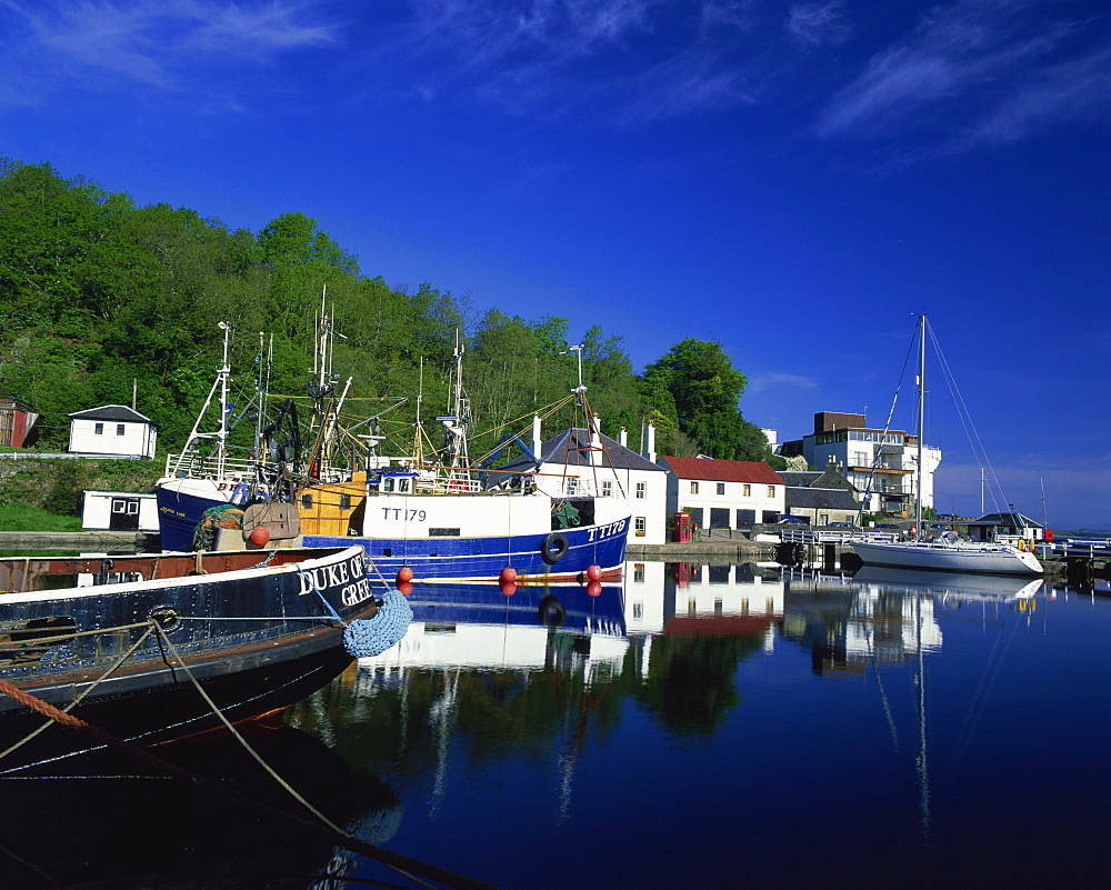 Tranquil scene of boats reflected in still water on the Crinan Canal, Crinan, Strathclyde, Scotland, United Kingdom, Europe