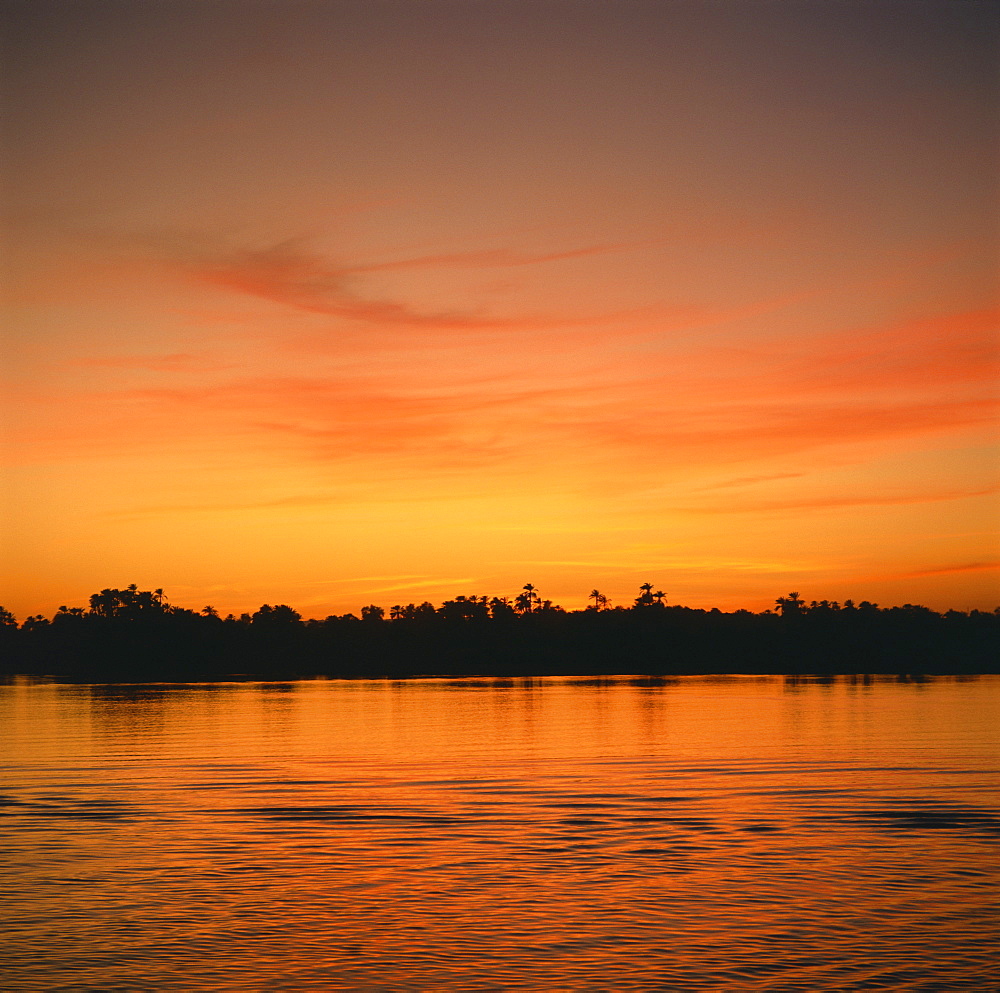 The River Nile at sunset, water reflecting evening sky, in Egypt, North Africa, Africa