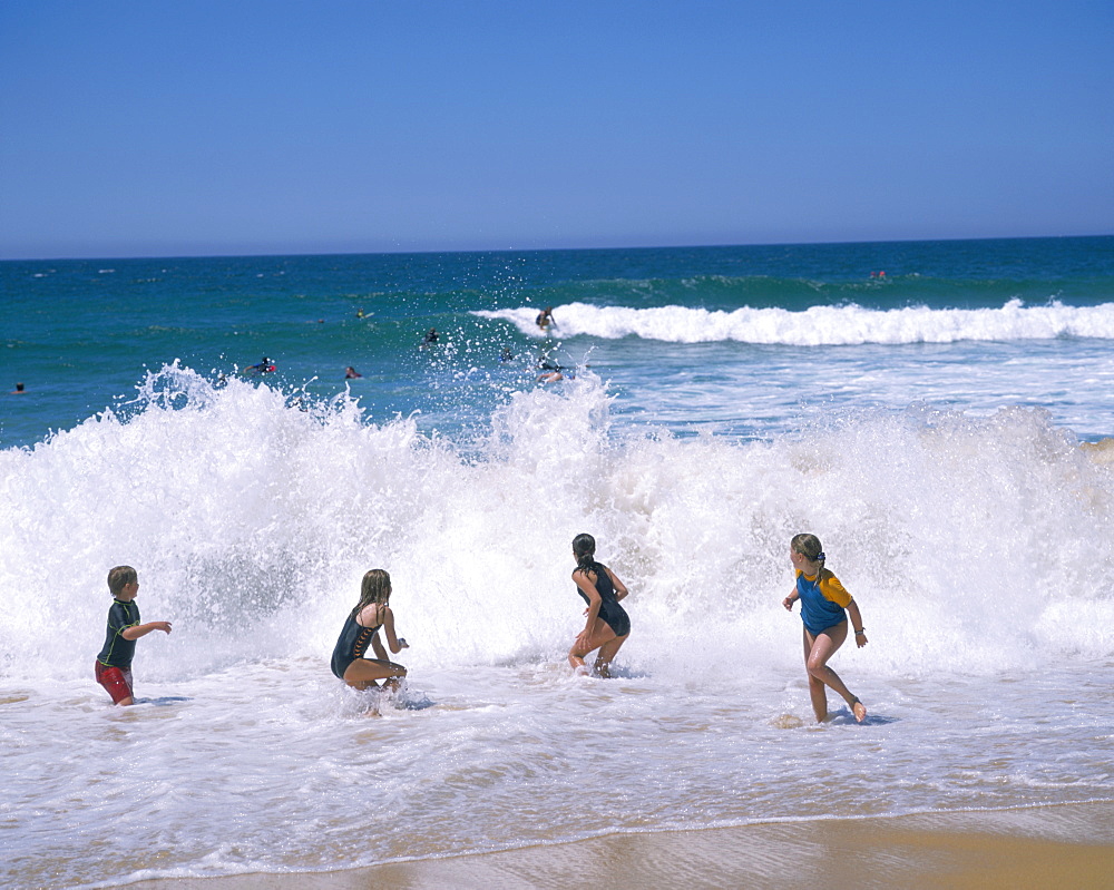 Children playing in the surf, Copacabana beach, near Gosford, north of Sydney, New South Wales, Australia, Pacific