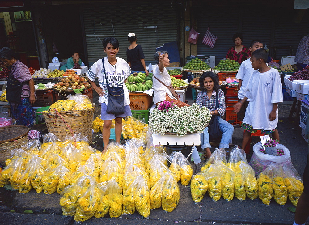 Women selling flowers and fruit from stalls in a street market in Bangkok, Thailand, Southeast Asia, Asia