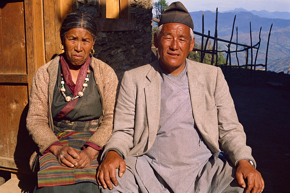 Portrait of an elderly Sherpa couple in traditional clothing, sitting outdoors, look at the camera, at Solu Khumbu, Nepal, Asia