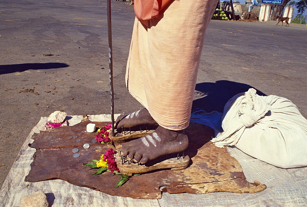 Close-up of the feet of a Hindu Saddhu or holy man standing on a bed of nails, in Mysore, Karnataka, India, Asia