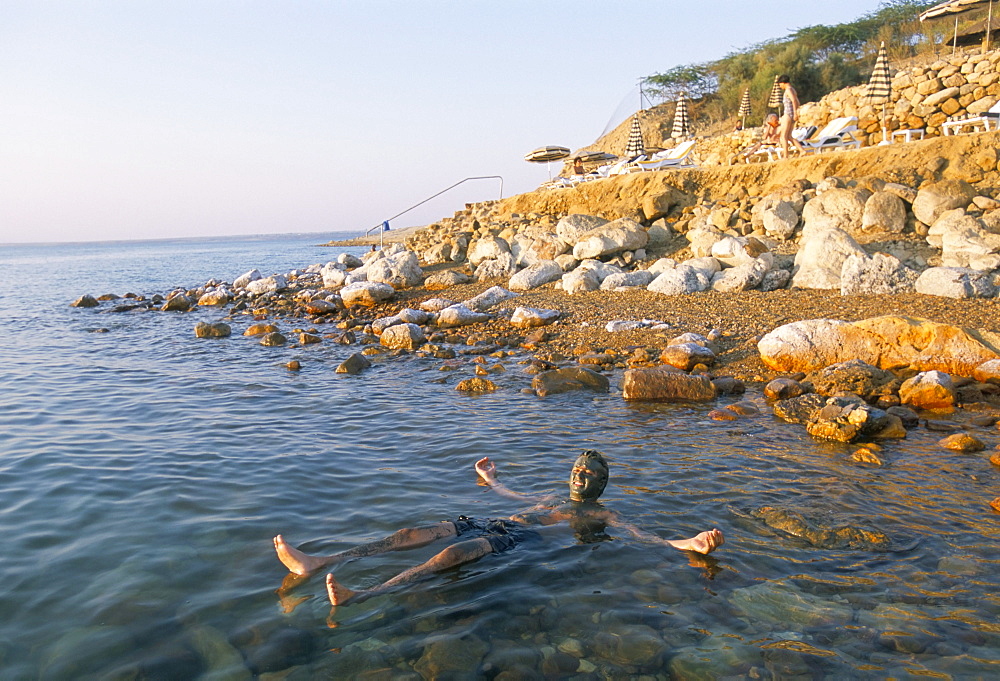 Man floating in Dead Sea, Jordan, Middle East