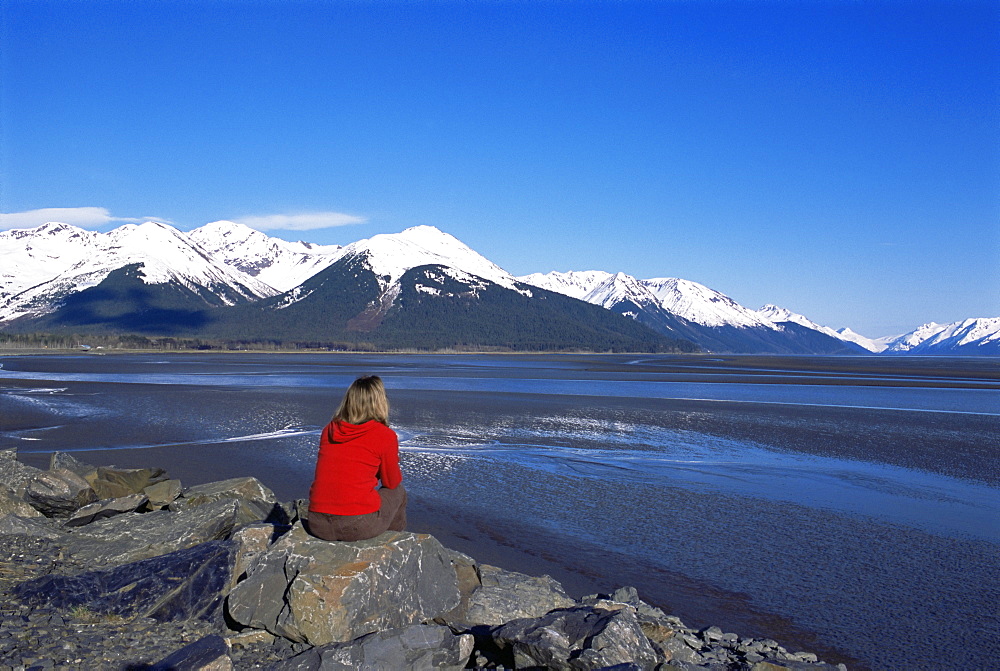 Woman looking at glaciers along the Seward Highway, Girdwood, Alaska, United States of America, North America