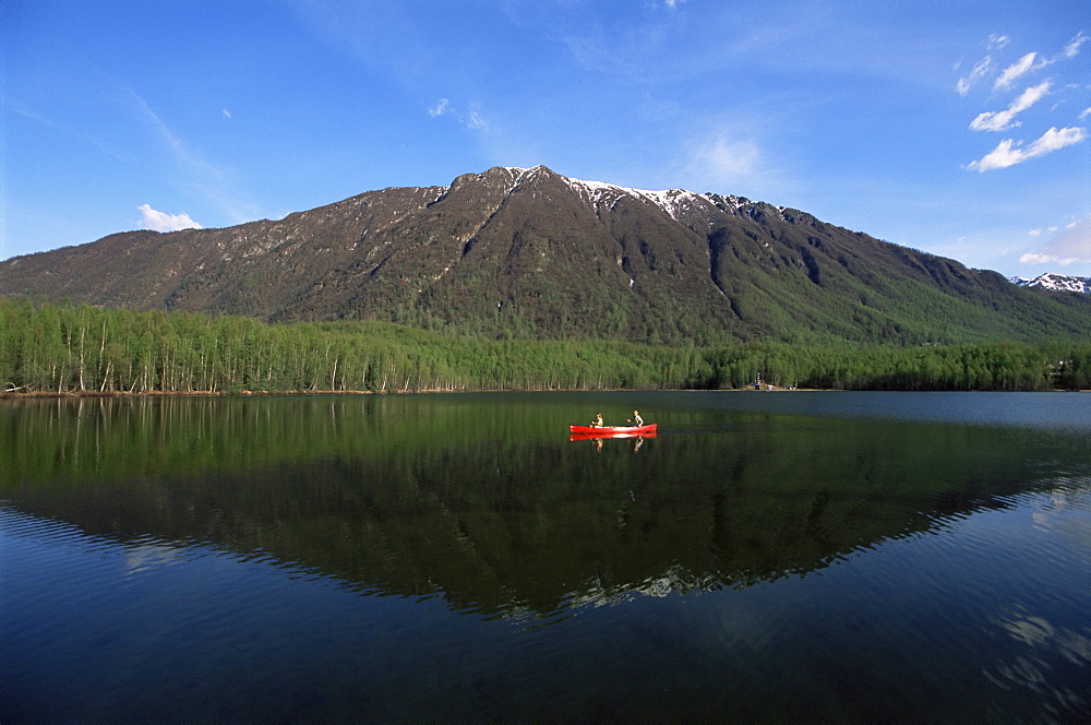 Man and woman canoeing in Mirror Lake, Chugach Mountains, Anchorage, Alaska, United States of America, North America