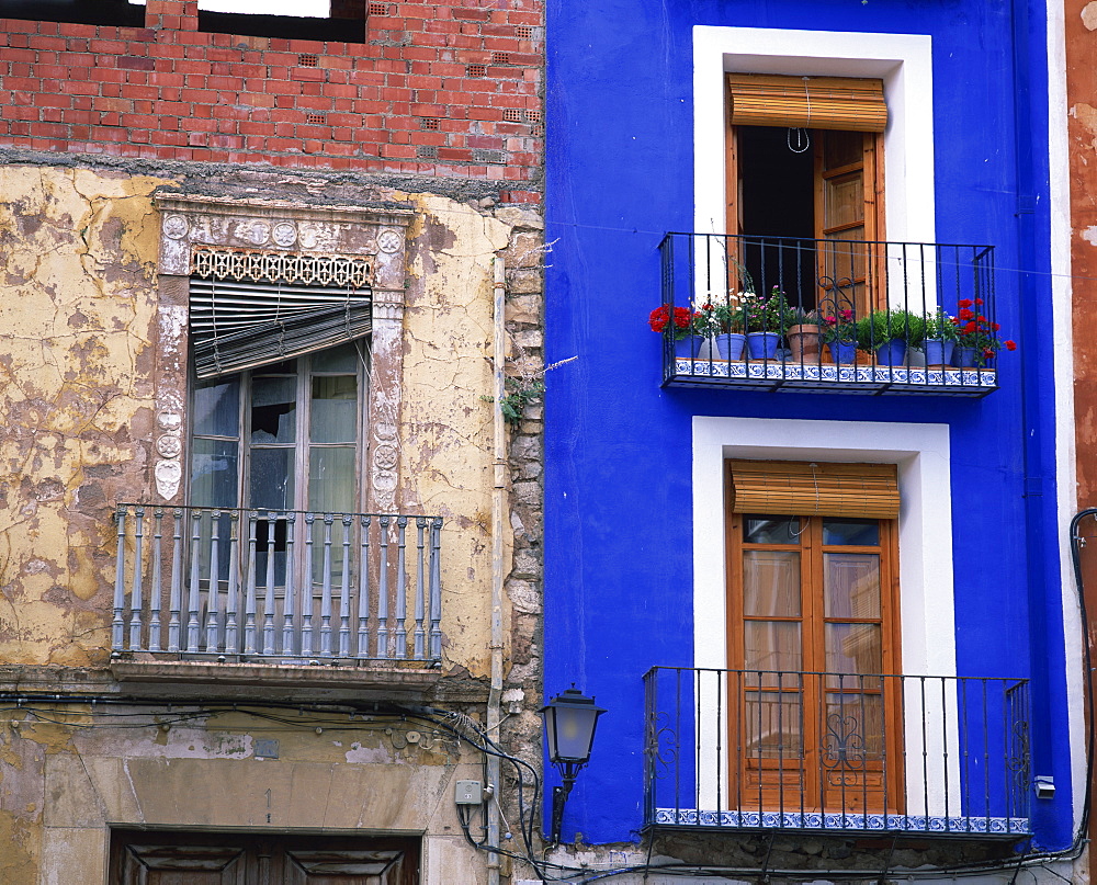 Contrast between derelict and bright blue painted lived in house in Villajoyosa in Valencia, Spain, Europe