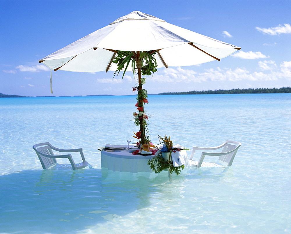 White table, chairs and parasol in the ocean, Bora Bora (Borabora), Tahiti, Society Islands, French Polynesia, South Pacific Islands, Pacific