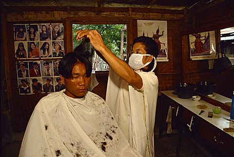 Lao barber, a returnee from camp in Thailand, Vientiane, Laos, Indochina, Southeast Asia, Asia