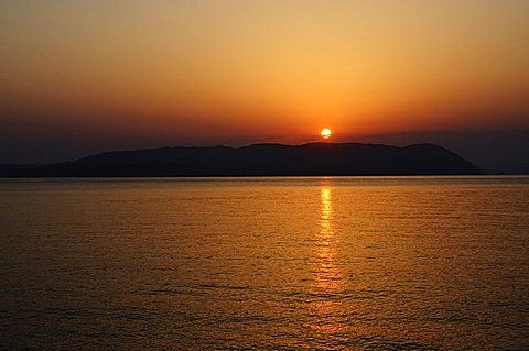 Sunset over the Aegean, taken from Loutraki, Skopelos, with Skiathos in background, Sporades Islands, Greek Islands, Greece, Europe