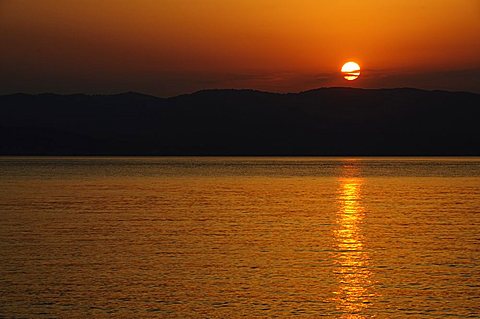 Sunset over the Aegean, taken from Loutraki, Skopelos, with Skiathos in background, Sporades Islands, Greek Islands, Greece, Europe