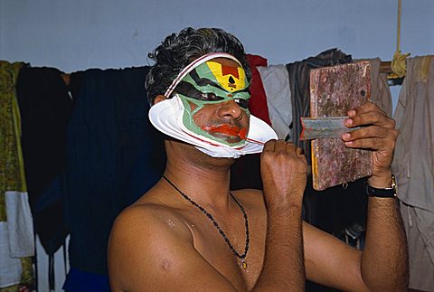 Kathakali dancer applying make-up, Kerala state, India, Asia