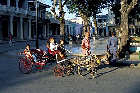 Goat cart with children on a Sunday in the Plaza de la Revolucion, Bayamo, Cuba, West Indies, Central America