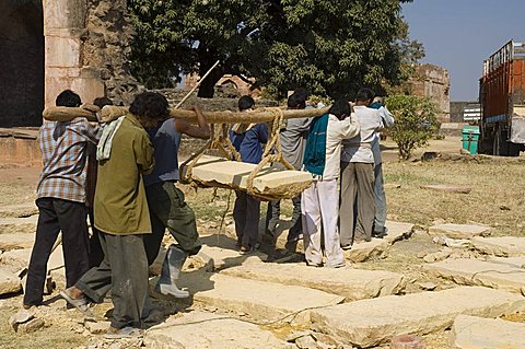 Lifting by hand heavy stones for restoration work, Mandu, Madhya Pradesh state, India, Asia