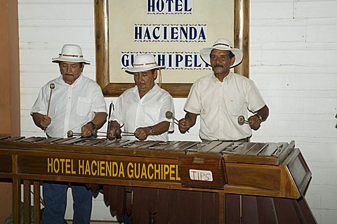 Musicians playing a type of xylophone, Hacienda Guachipelin, near Rincon de la Vieja National Park, Guanacaste, Costa Rica, Central America