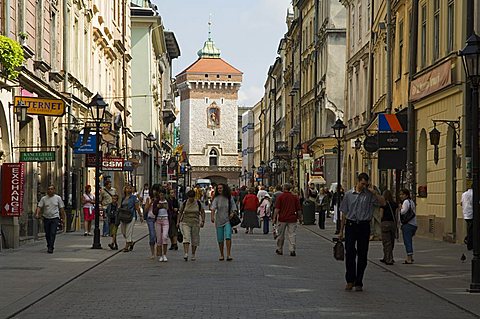 Looking down Florianska street towards the Barbican and Florian's Gate on the old city walls, UNESCO World Heritage Site, Krakow (Cracow), Poland, Europe