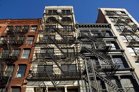 Fire escapes on the outside of buildings in Spring Street, Soho, Manhattan, New York City, New York, United States of America, North America