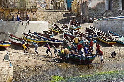 Fishermen taking boat out of water at the port of Ponto do Sol, Ribiera Grande, Santo Antao, Cape Verde Islands, Atlantic, Africa