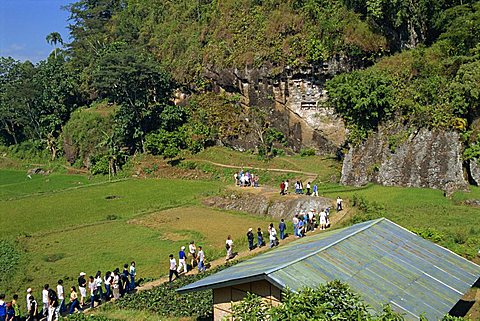 Tourist group on visit to Lemo cliff tombs, Toraja area, Sulawesi, Indonesia, Southeast Asia, Asia