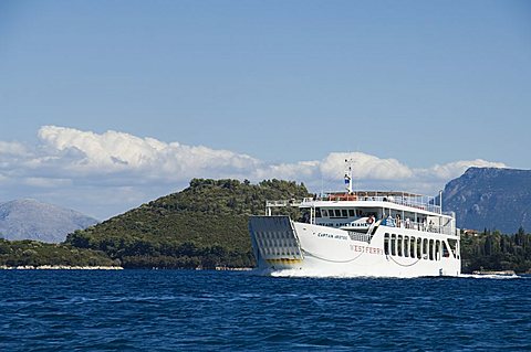 Ferry passing the Island of Skorpios owned by the Onassis family, near Lefkada (Lefkas), Ionian Islands, Greek Islands, Greece, Europe