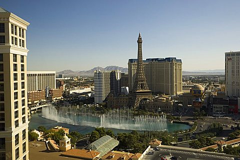 View of Paris Hotel and lake of Bellagio Hotel with its famous fountains, on the Strip (Las Vegas Boulevard), Las Vegas, Nevada, United States of America, North America