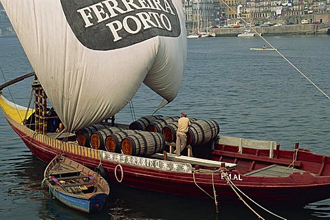 Casks of port on a barge on the Douro River in Porto, Portugal, Europe