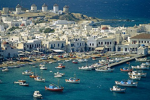 Aerial of the harbour and Mykonos town with windmills in the background, Mykonos, Cyclades Islands, Greece