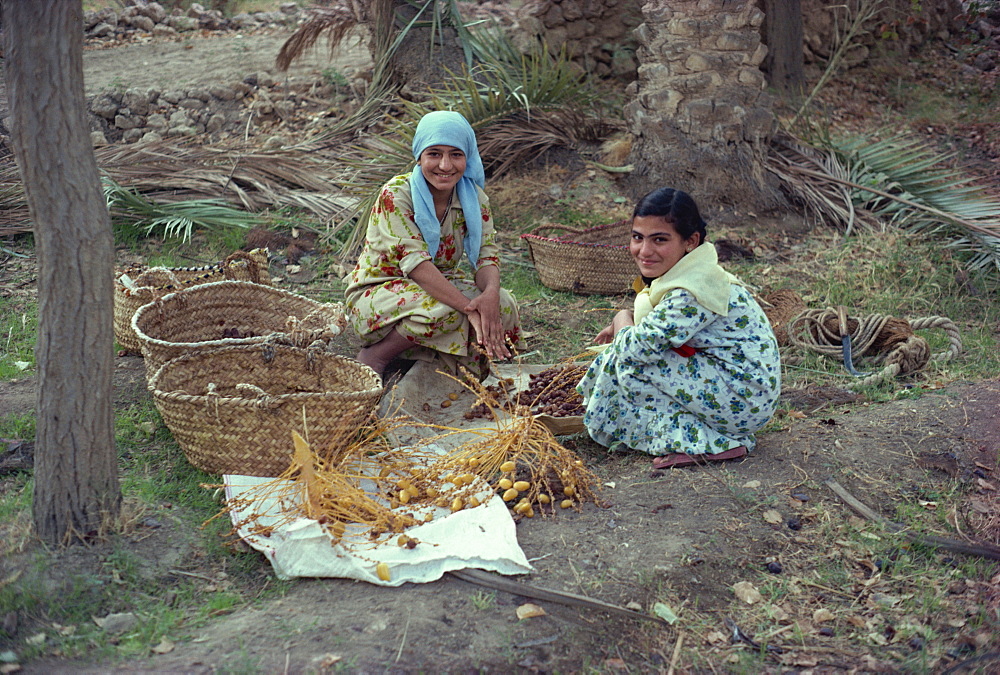 Portrait of two young girls collecting dates, Qa'lat'ana, Iraq, Middle East