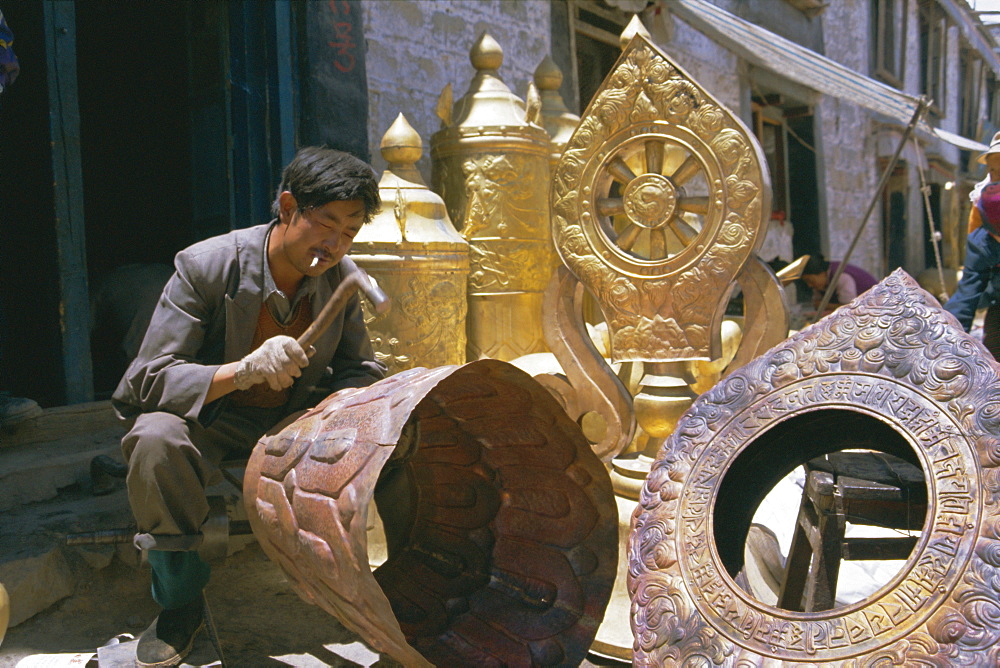 Metalsmith making temple ornaments, Lhasa, Tibet, China, Asia