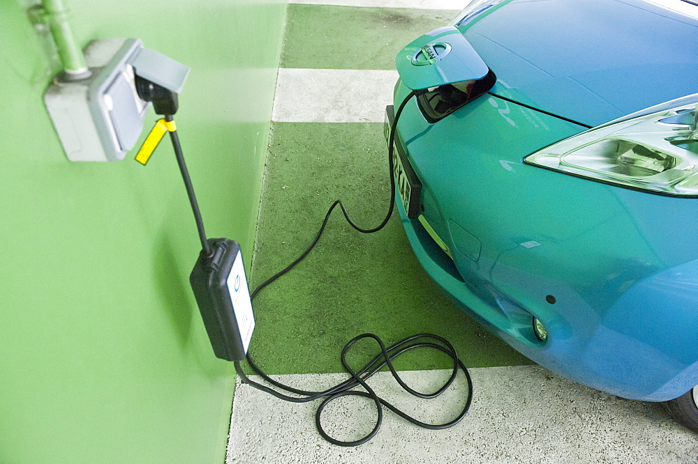 A Nissan Leaf Electric Car being charged at a Car Park in Annecy, France, Europe