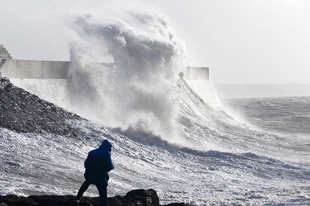 Waves crash against the harbour wall at Porthcawl, Bridgend, Wales, United Kingdom, Europe