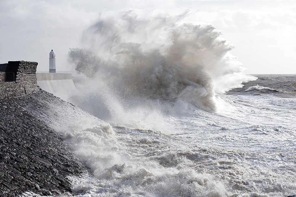 Waves crash against the harbour wall at Porthcawl, Bridgend, Wales, United Kingdom, Europe