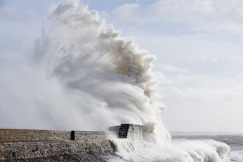 Waves crash against the harbour wall at Porthcawl, Bridgend, Wales, United Kingdom, Europe