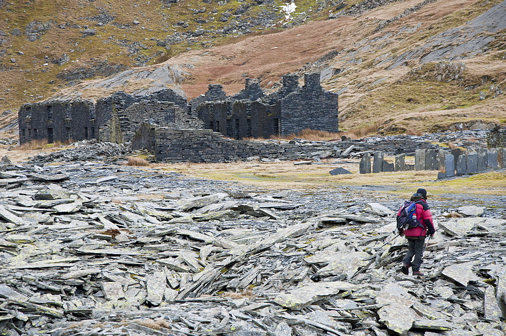 A hiker walks through the abandoned Croesor Slate Mines, Croesor, Gwynedd, Snowdonia National Park, Wales, United Kingdom, Europe