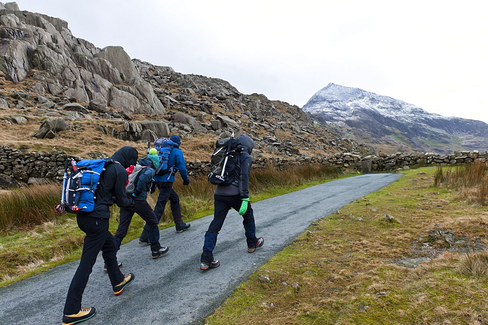 Hikers set off from Pen Y Pass in winter to climb Mount Snowdon in Snowdonia National Park, Gwynedd, Wales, United Kingdom, Europe